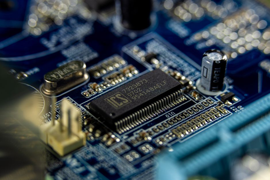 Detailed shot of a microprocessor on a blue motherboard showcasing electronic components