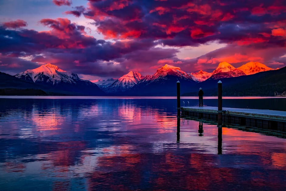 Stunning sunset over a serene lake with colorful sky and majestic mountains